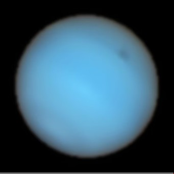 Captan por primera vez desde la Tierra una misteriosa mancha oscura en Neptuno