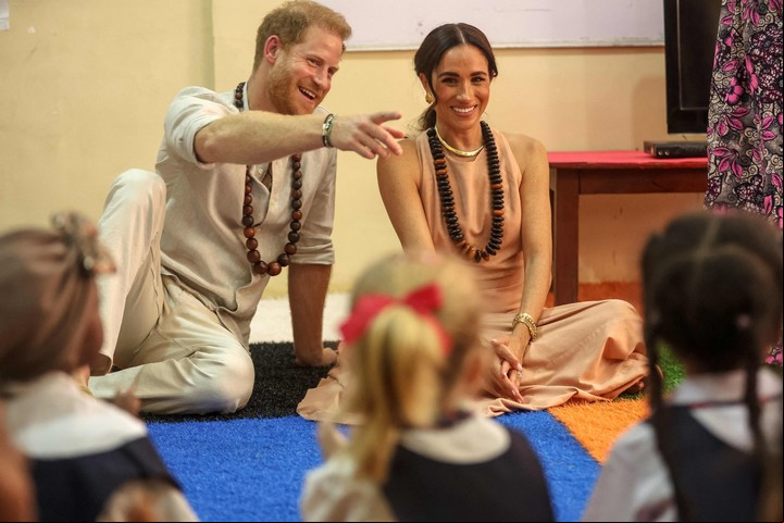 El príncipe Harry y Meghan se reúnen con niños durante su visita a la Lightway Academy en Abuja en mayo pasado. Foto AFP