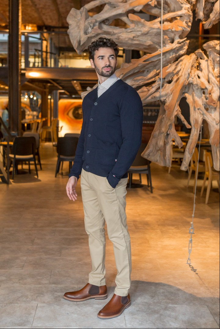 Azul marino + camel. Cárdigan de lana con botones y camisa de poplín estampada (Tommy Hilfiger), pantalón chino de gabardina (Calvin Klein) y botinetas de cuero (Oggi). Foto: Esteban Leyba.