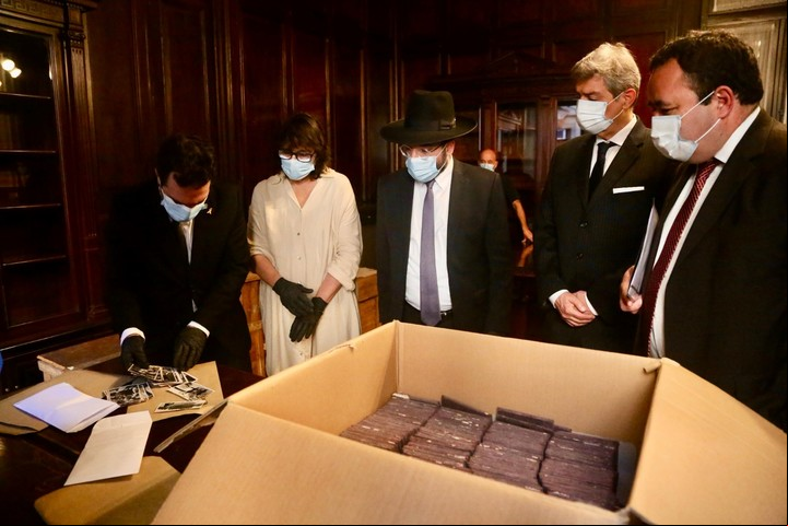 El director del Museo del Holocausto, Jonathan Karszembau (primero a la izq) con Rosati abren una caja nazi.